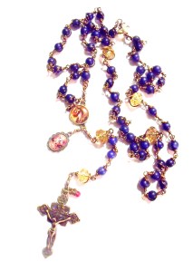 Bronze color crucifix, Mary Undoer of Knots center, St. Michael medal, natural lapis beads, faceted glass beads and a 'drop of His blood'