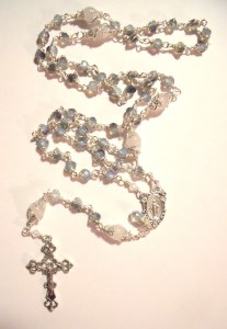silver tone crucifix, center with moonstone flanked crystal, blue/white opal glass beads and Mary's tear.