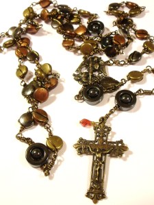 True bronze St. Michael center and Crucifix. bronze color findings. 'a drop of His blood' crystal